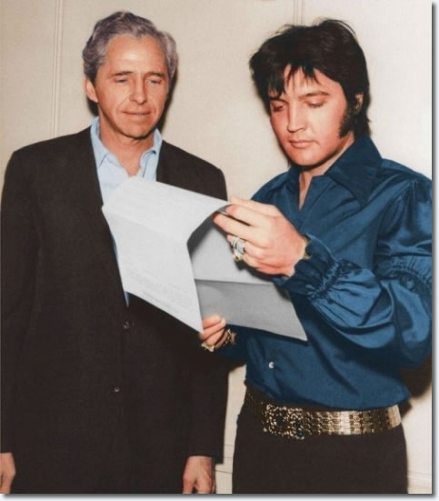 Elvis examining the That's The Way It Is contract with Hilton Hotels Manager Alex Shofey